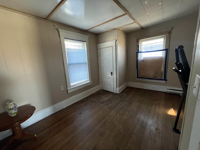 203 Juniper St, Bluefield, WV 24701 - unfurnished bedroom featuring dark wood-style floors, multiple windows, and baseboards