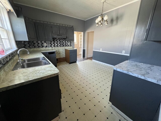203 Juniper St, Bluefield, WV 24701 - kitchen featuring light floors, light countertops, hanging light fixtures, ornamental molding, and a sink