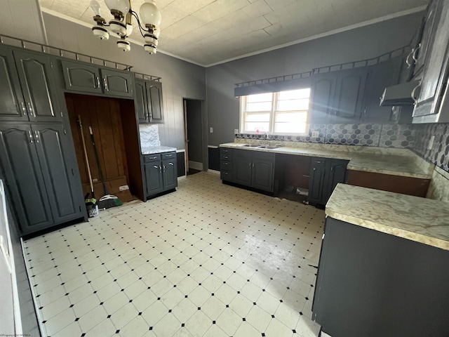 203 Juniper St, Bluefield, WV 24701 - kitchen featuring light countertops, ornamental molding, light floors, and a sink