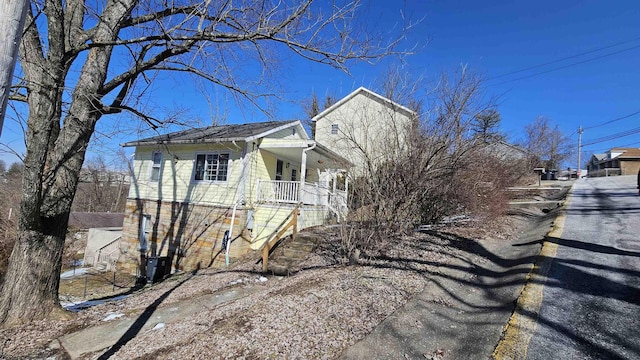 view of side of property featuring a porch