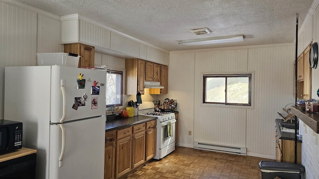 kitchen with brown cabinetry, dark countertops, a baseboard radiator, under cabinet range hood, and black appliances