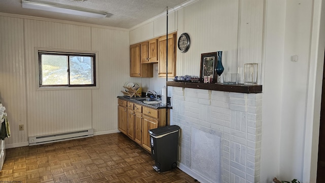 kitchen featuring a textured ceiling, baseboard heating, dark countertops, and brown cabinets