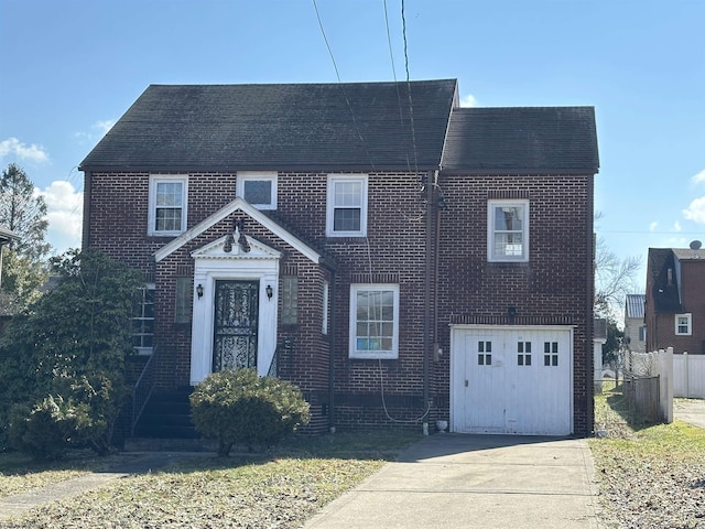 view of front facade featuring driveway, an attached garage, fence, and brick siding