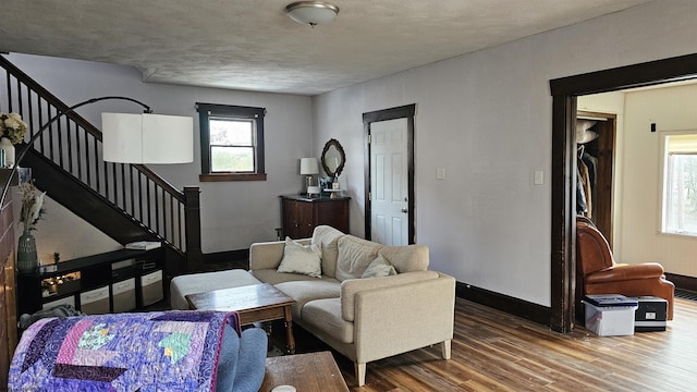 living room with baseboards, stairway, and wood finished floors