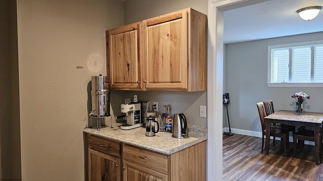 kitchen with baseboards and dark wood-style flooring