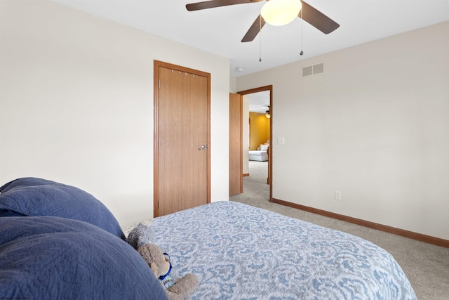 bedroom featuring a ceiling fan, carpet, visible vents, and baseboards