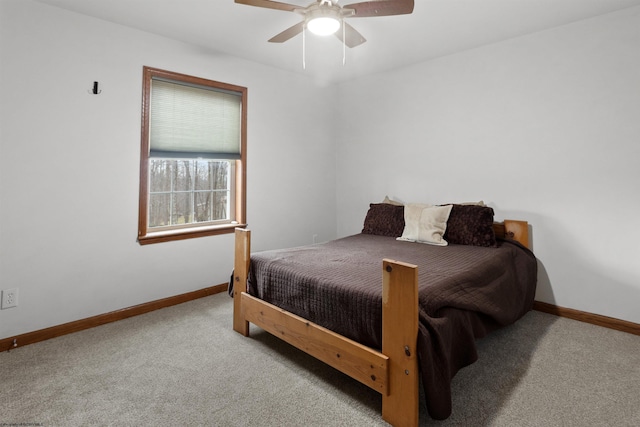 carpeted bedroom featuring ceiling fan and baseboards