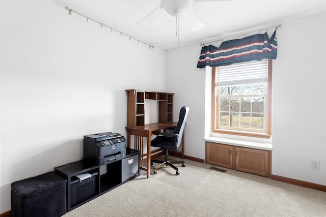 office with a ceiling fan, visible vents, light carpet, and baseboards