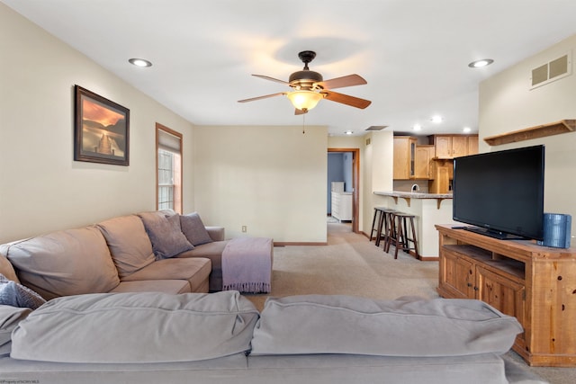 living room with recessed lighting, light carpet, a ceiling fan, visible vents, and baseboards