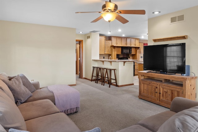 living room featuring recessed lighting, light colored carpet, visible vents, ceiling fan, and baseboards