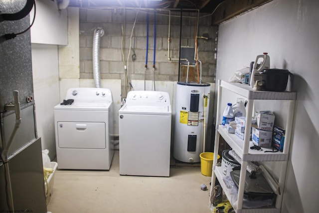 clothes washing area featuring laundry area, washer and dryer, and electric water heater