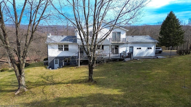 back of house featuring a balcony, a deck, and a yard