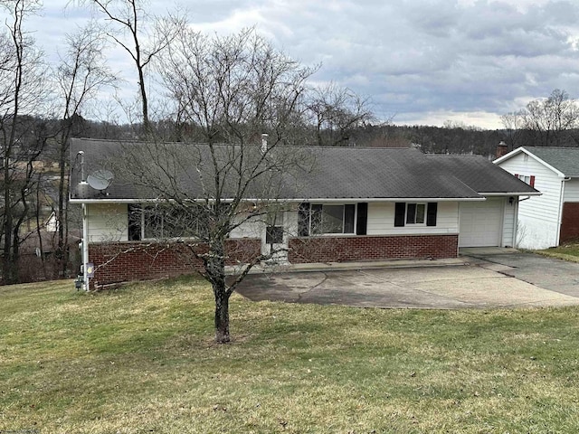 single story home featuring a garage, driveway, brick siding, and a front yard