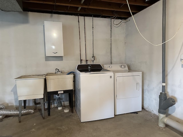 washroom featuring laundry area, a sink, and washer and dryer