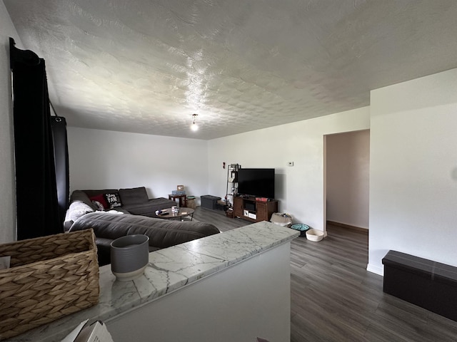 living room featuring baseboards and dark wood-style flooring