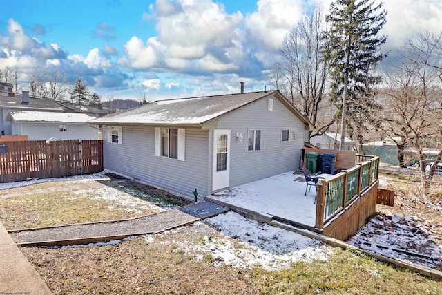 rear view of house with a patio and fence