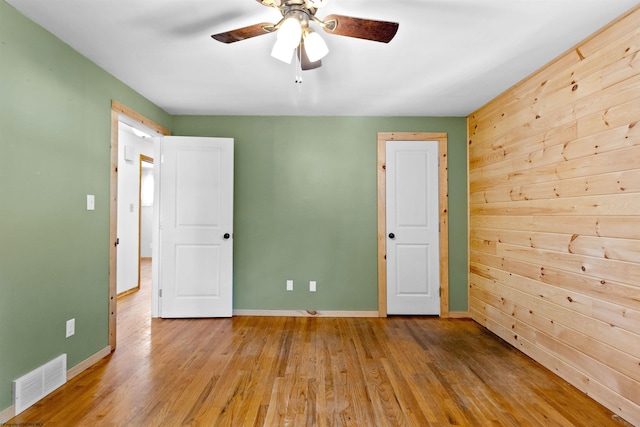 unfurnished room with baseboards, visible vents, and light wood-style floors