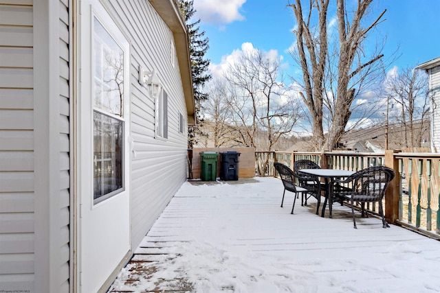 snow covered deck with outdoor dining space