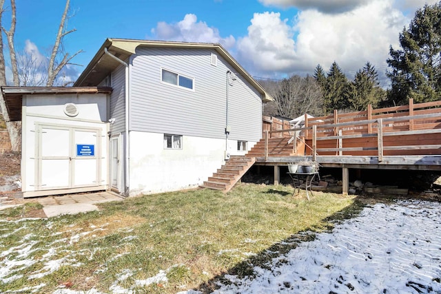 rear view of house featuring a yard, stairway, and a wooden deck