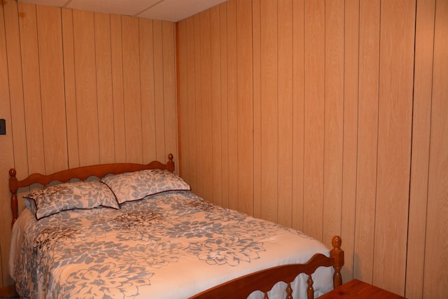 bedroom with wooden walls