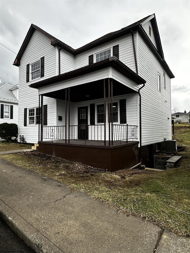 view of front facade with covered porch and cooling unit