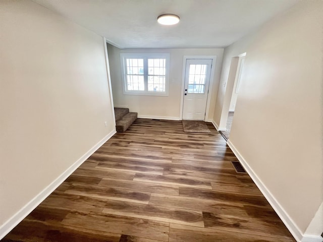 doorway to outside featuring stairway, dark wood finished floors, and baseboards