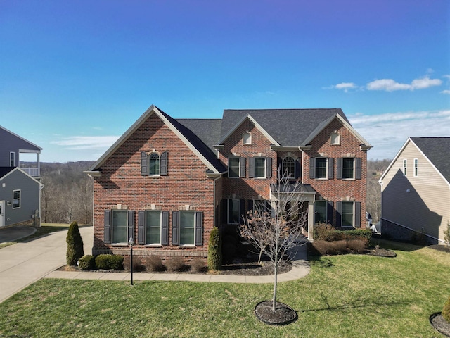 view of front facade featuring brick siding and a front lawn