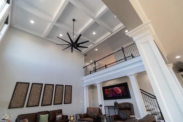 living room with decorative columns, stairway, a high ceiling, ceiling fan, and coffered ceiling