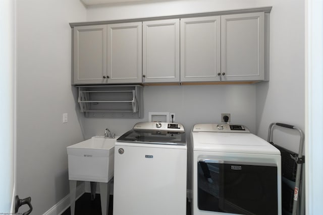 laundry room with washer and clothes dryer, a sink, cabinet space, and baseboards