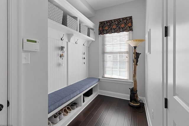 mudroom with dark wood-style floors and baseboards