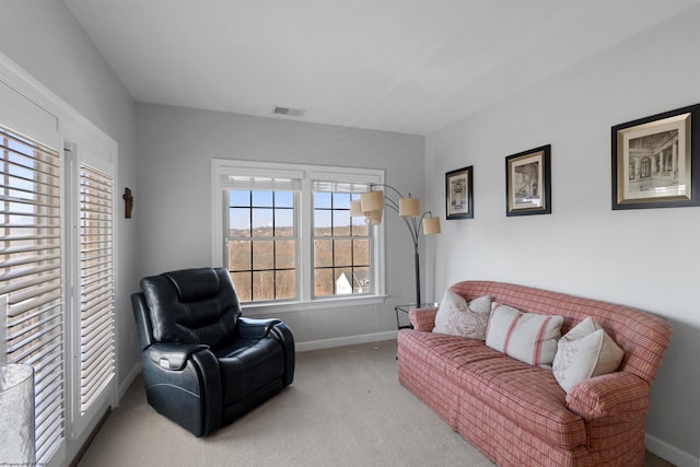 carpeted living room with visible vents and baseboards