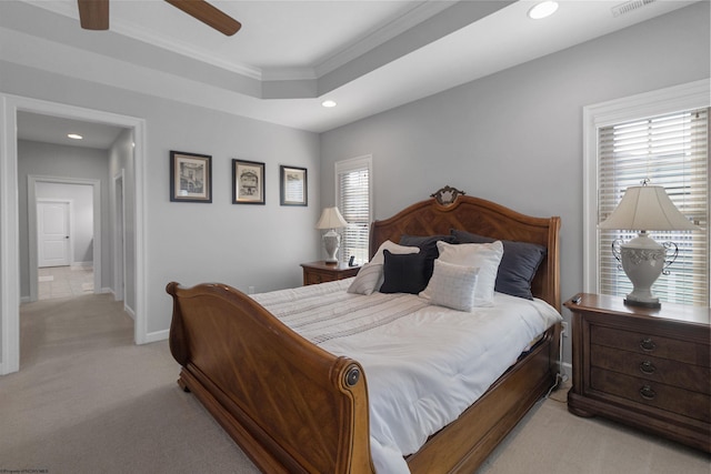 bedroom with baseboards, a ceiling fan, light colored carpet, a tray ceiling, and recessed lighting