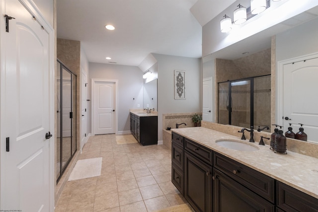 full bathroom featuring a shower stall, two vanities, a sink, and tile patterned floors