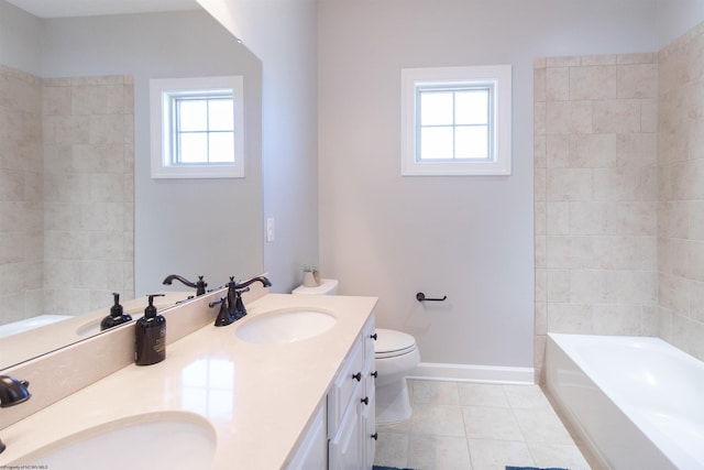 full bath with baseboards, a sink, a tub, and tile patterned floors