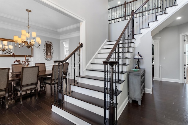 stairs featuring a notable chandelier, ornamental molding, wood finished floors, and baseboards