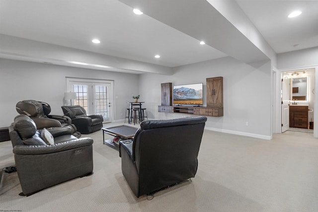 living room with recessed lighting, french doors, light colored carpet, and baseboards