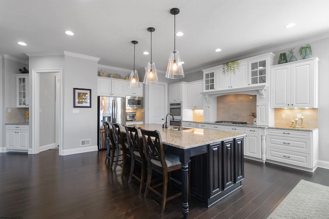 kitchen featuring dark wood-type flooring, a sink, visible vents, white cabinets, and appliances with stainless steel finishes