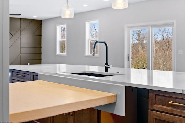 kitchen with a sink, decorative light fixtures, and recessed lighting