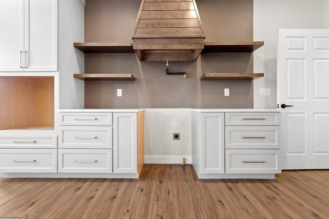 kitchen featuring open shelves, light wood-type flooring, light countertops, and white cabinetry