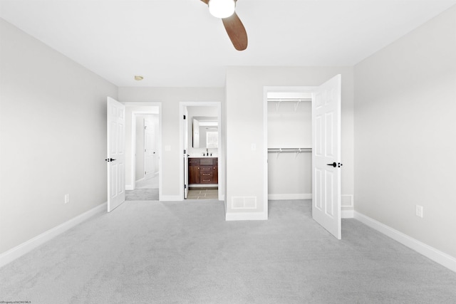 unfurnished bedroom with baseboards, visible vents, ceiling fan, and light colored carpet