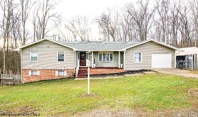 ranch-style home with driveway, an attached garage, fence, and a front yard