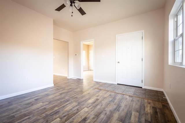 unfurnished bedroom with a ceiling fan, baseboards, and wood finished floors