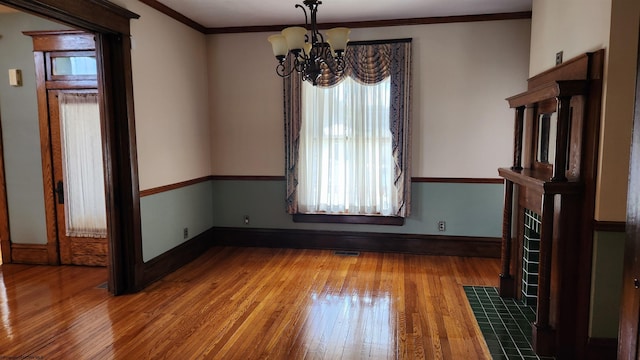 unfurnished dining area featuring a healthy amount of sunlight, hardwood / wood-style flooring, and visible vents