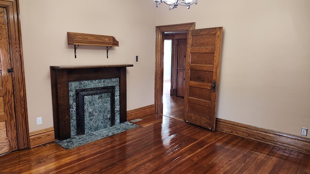 unfurnished living room featuring hardwood / wood-style flooring, visible vents, baseboards, and a tile fireplace