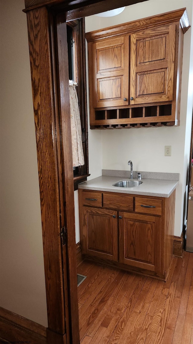 kitchen featuring light countertops, a sink, and light wood-style floors