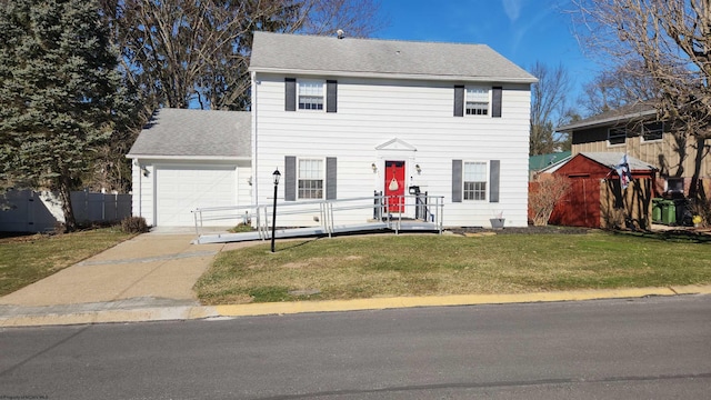 colonial inspired home featuring a shingled roof, concrete driveway, an attached garage, a front yard, and fence