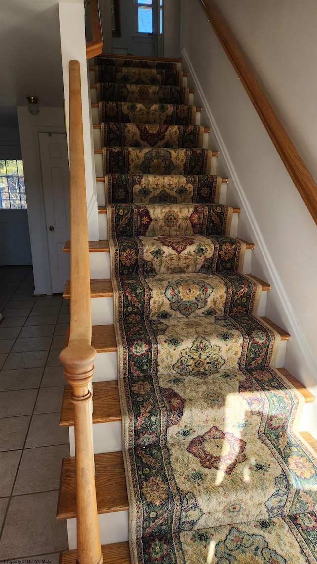 stairway with tile patterned flooring and baseboards