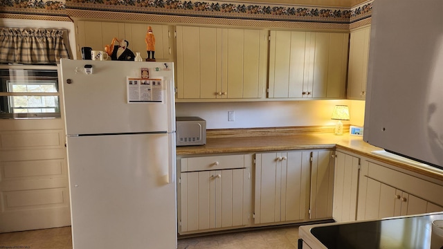 kitchen featuring light countertops and white appliances