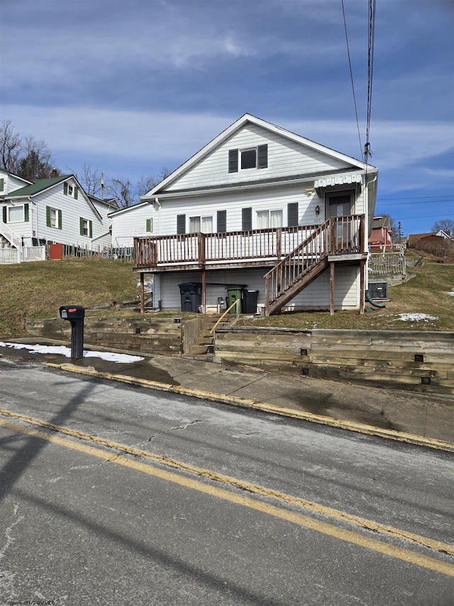 view of front of property with stairs and a deck