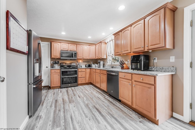 kitchen featuring light wood finished floors, recessed lighting, stainless steel appliances, and light brown cabinetry